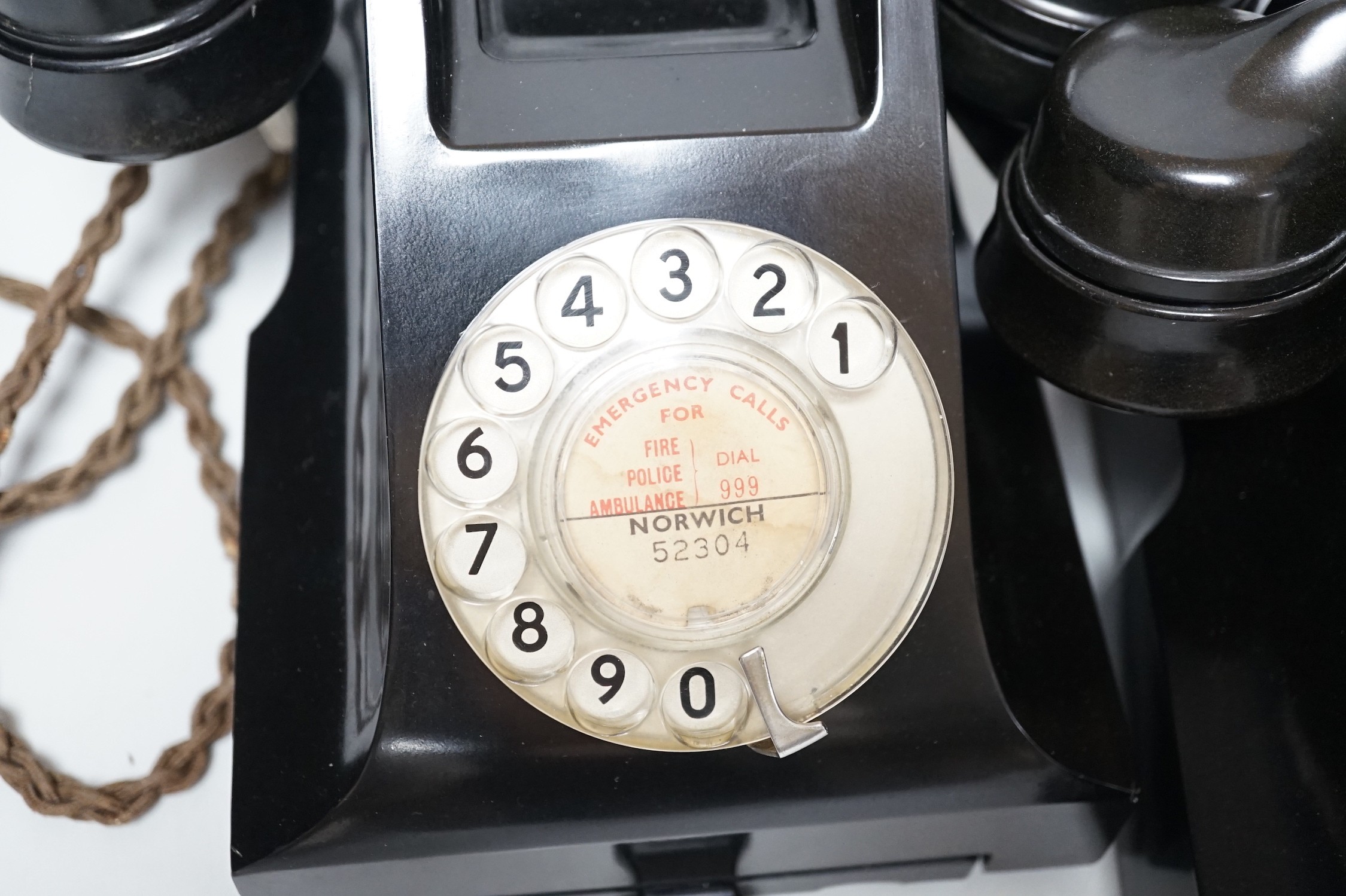 Two black Bakelite telephones with drawers